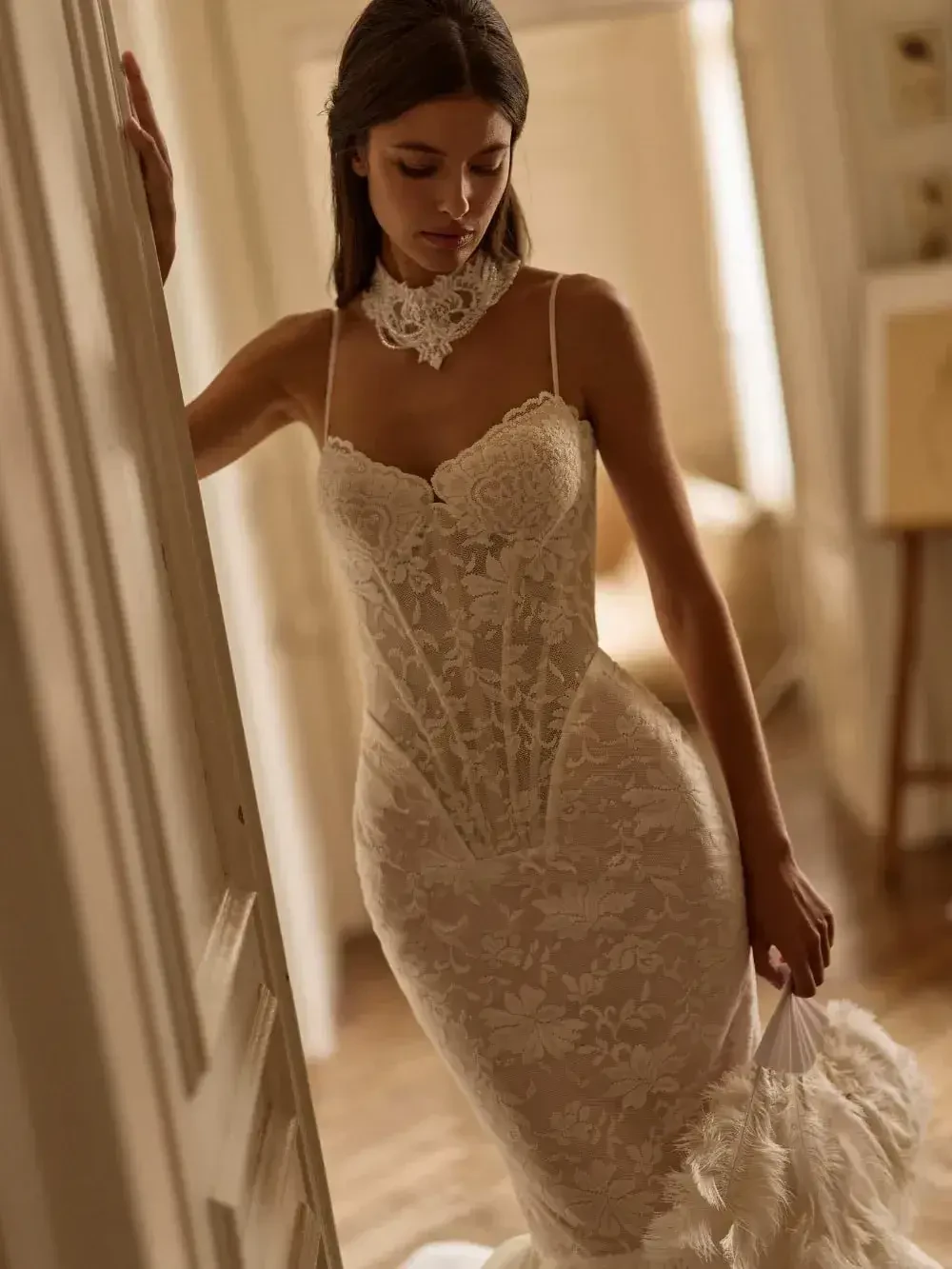 model is wearing an elaborate strapless bridal gown