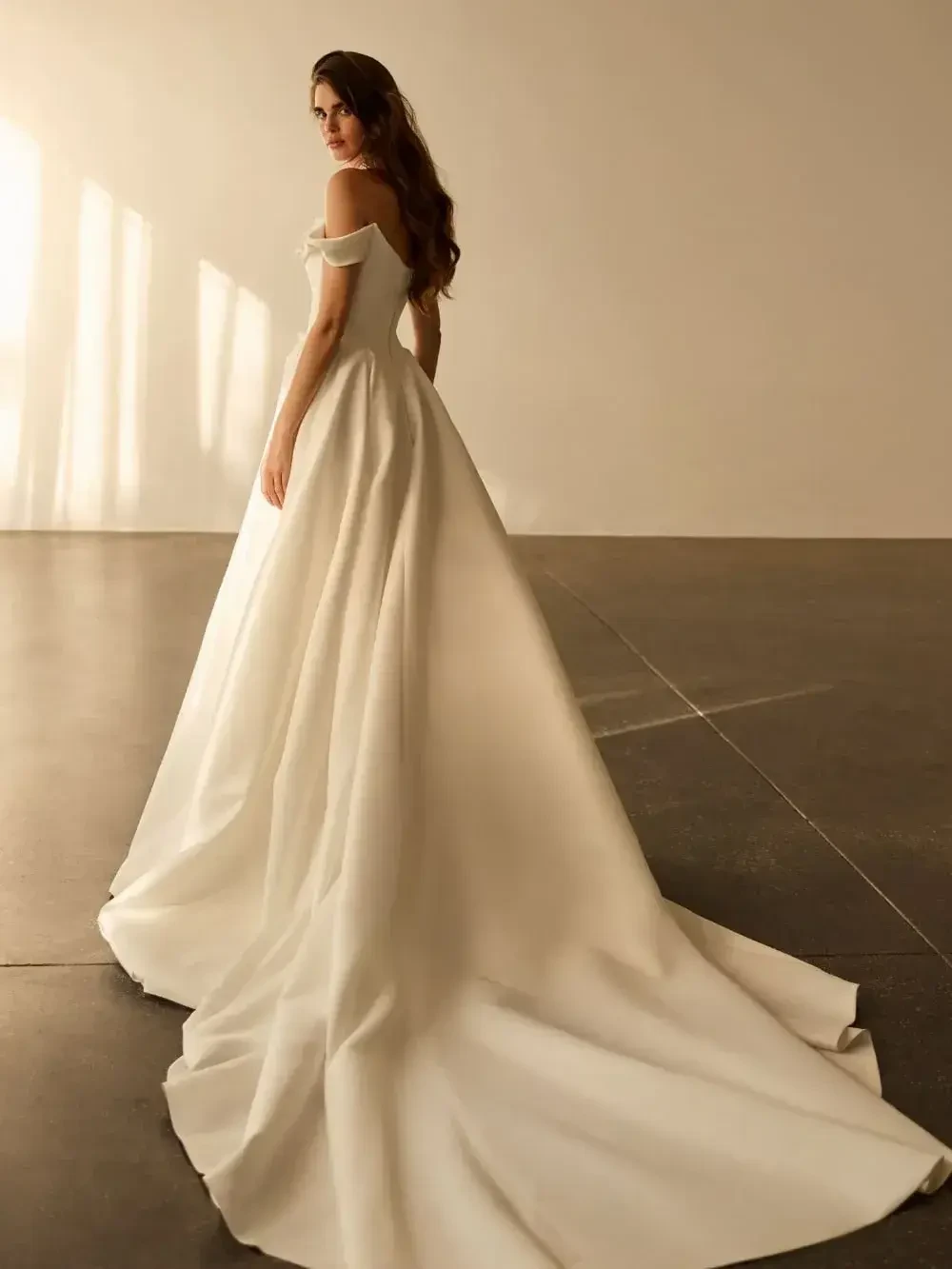 model is wearing a beautiful ball gown wedding dress